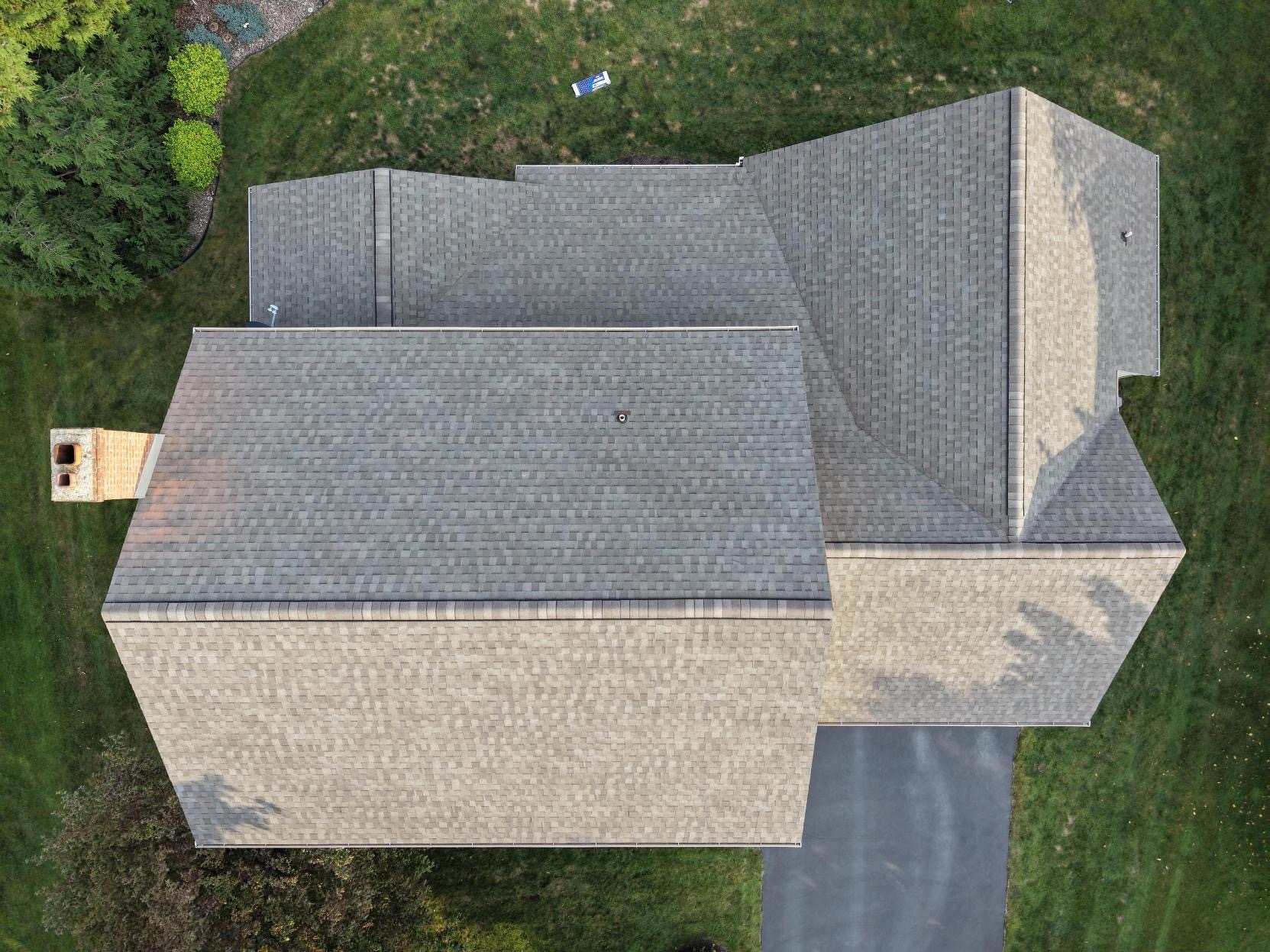 Aerial view of a home with a completed gray shingle roof